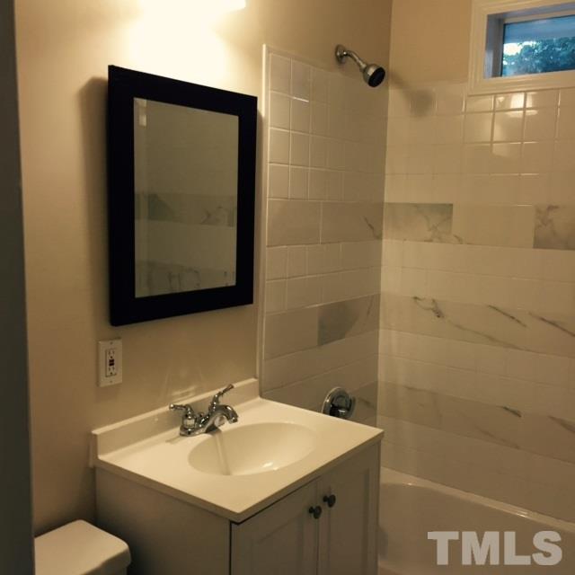 722 Newcombe Road Raleigh, NC 27610 - Photo 10 of 19 a bathroom with a sink and a mirror