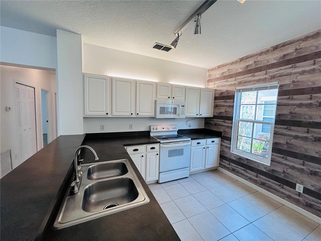 904 Pawstand Road Kissimmee, FL 34747 - Photo 12 of 22 a kitchen that has a sink and a stove