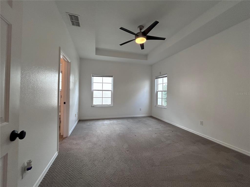 904 Pawstand Road Kissimmee, FL 34747 - Photo 14 of 22 an empty room with windows and fan