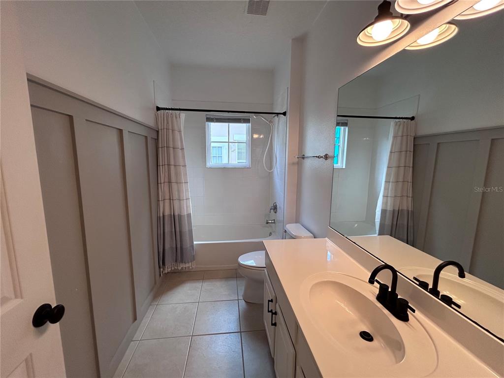 904 Pawstand Road Kissimmee, FL 34747 - Photo 19 of 22 a bathroom with a sink and mirror