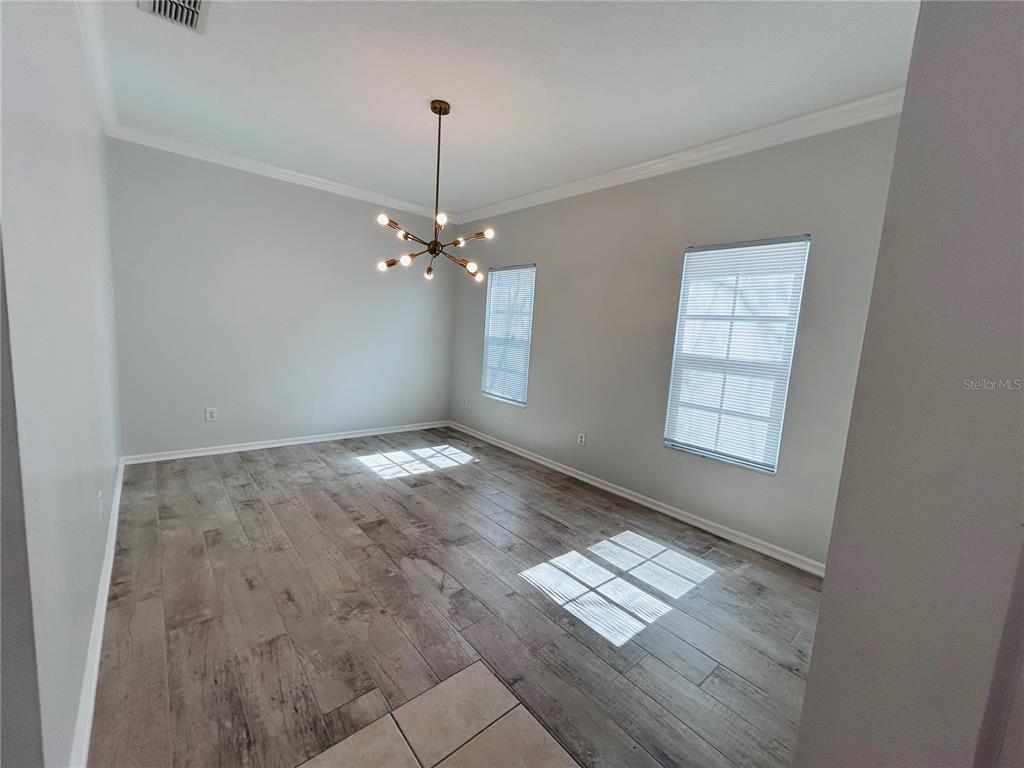 904 Pawstand Road Kissimmee, FL 34747 - Photo 9 of 22 an empty room with kitchen view