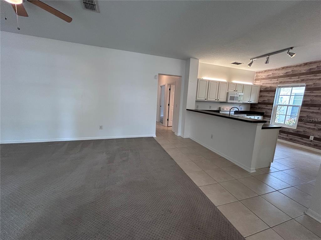 904 Pawstand Road Kissimmee, FL 34747 - Photo 10 of 22 a kitchen with stainless steel appliances a sink a stove top oven a counter space and cabinets
