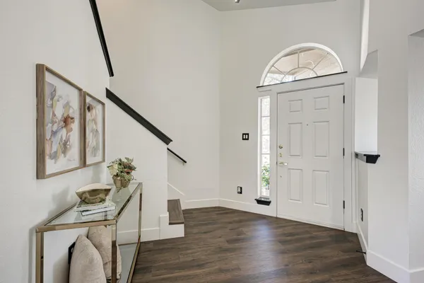 a view of a livingroom with wooden floor and stairs