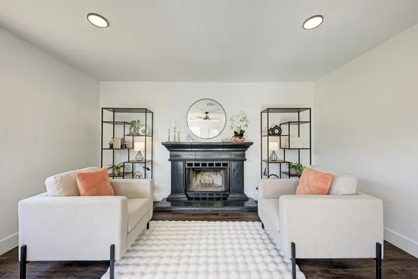 a living room with furniture a clock and a fireplace