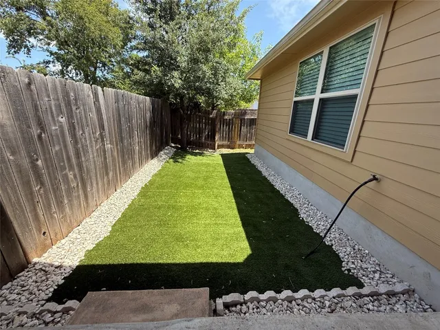 a view of house with backyard