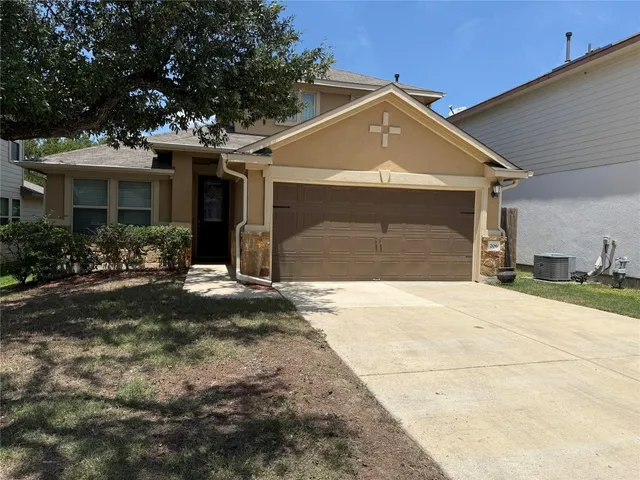 a front view of a house with a yard and garage