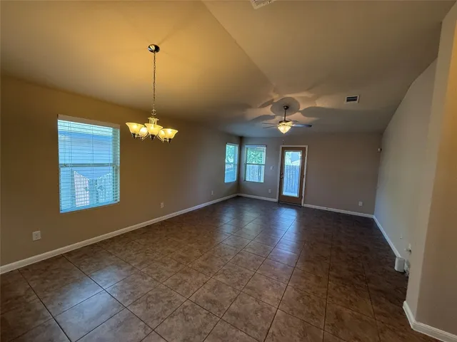 a view of a livingroom with a ceiling fan and window
