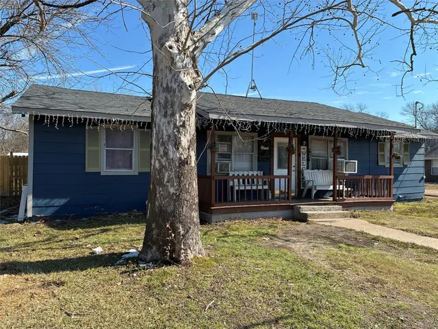 a view of a house with backyard porch and sitting area