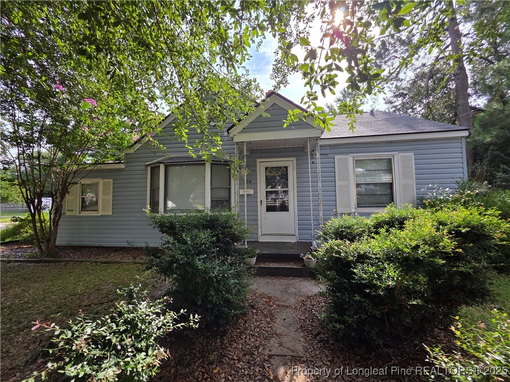 124 North Wright Street Raeford, NC 28376 - Photo 1 of 17 a front view of house with yard and green space