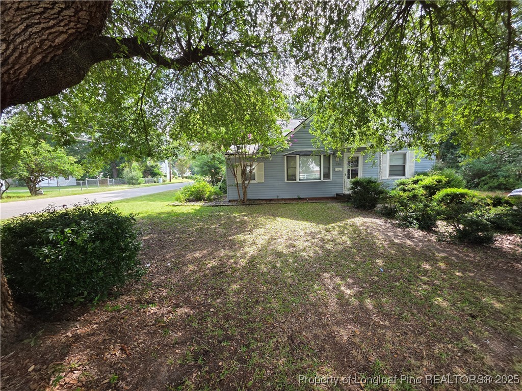 124 North Wright Street Raeford, NC 28376 - Photo 14 of 17 a view of a house with yard and a garden