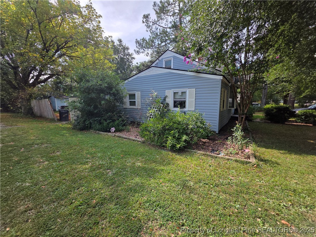 124 North Wright Street Raeford, NC 28376 - Photo 15 of 17 a front view of a house with garden