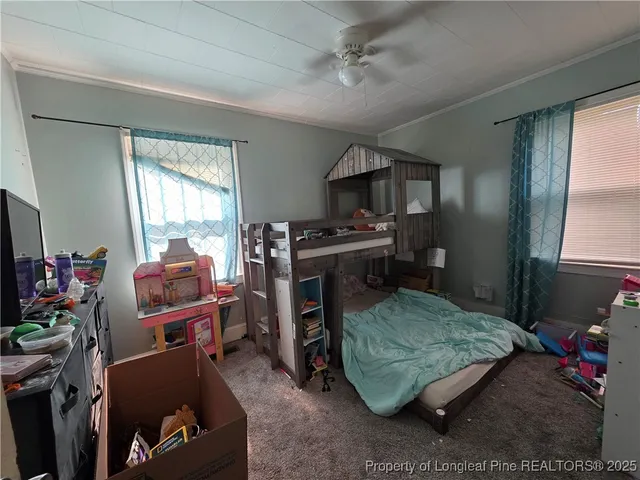 a bedroom with bed and a window