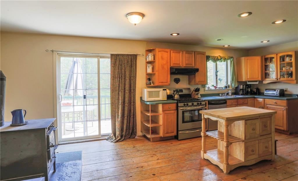 Kitchen with wood floor, slider to...