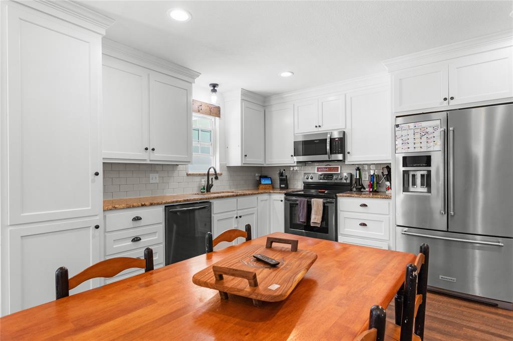 900 Bosque Street Meridian, TX 76665 - Photo 13 of 30 a kitchen with stainless steel appliances a stove refrigerator sink and microwave