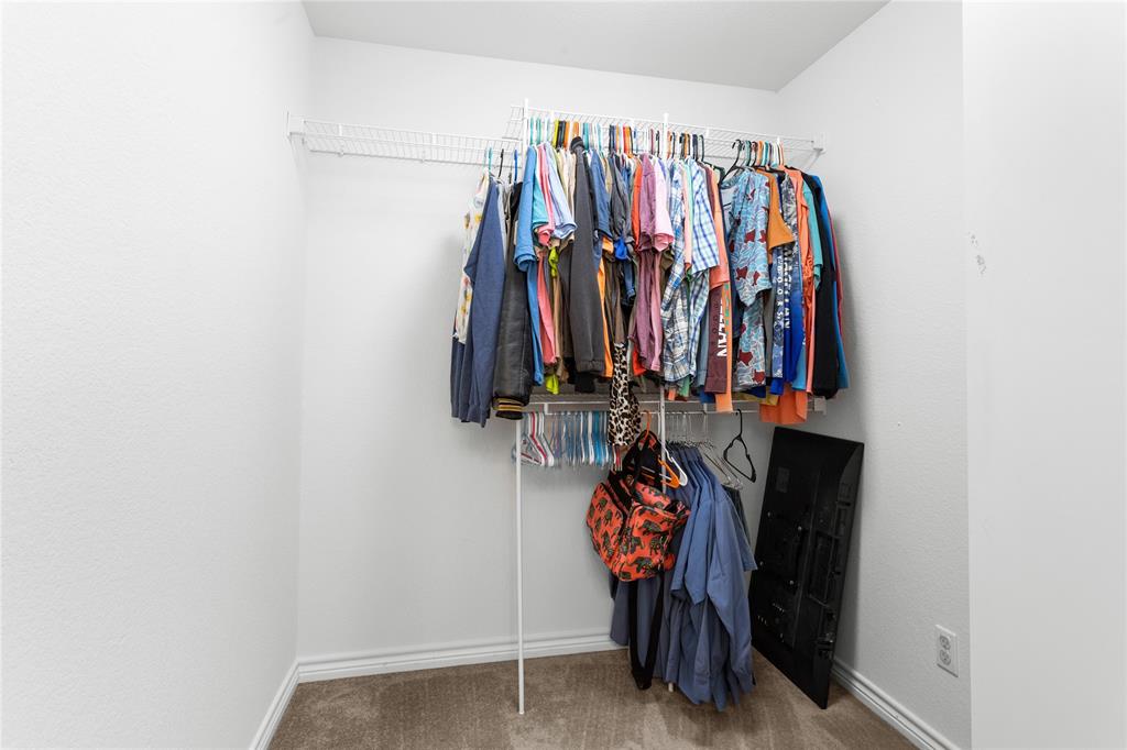900 Bosque Street Meridian, TX 76665 - Photo 20 of 30 a view of walk in closet with clothes