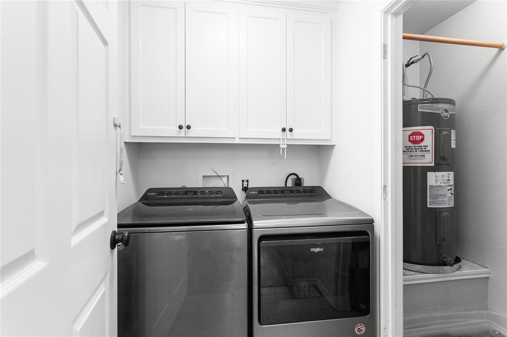 900 Bosque Street Meridian, TX 76665 - Photo 21 of 30 a kitchen with stainless steel appliances granite countertop a stove a refrigerator and a sink