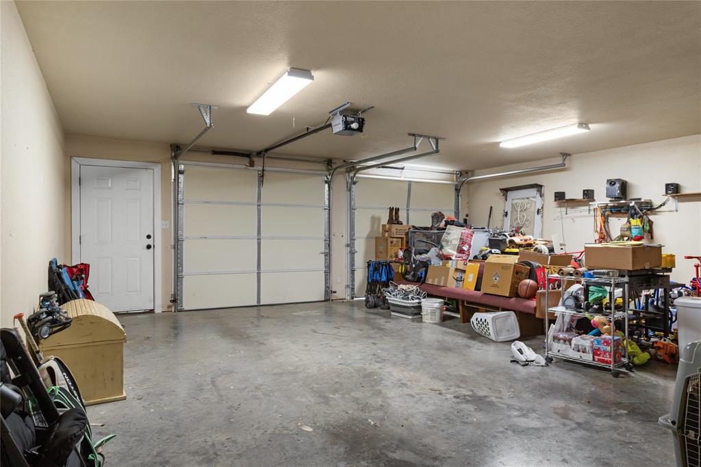 900 Bosque Street Meridian, TX 76665 - Photo 22 of 30 a garage with a bike and car