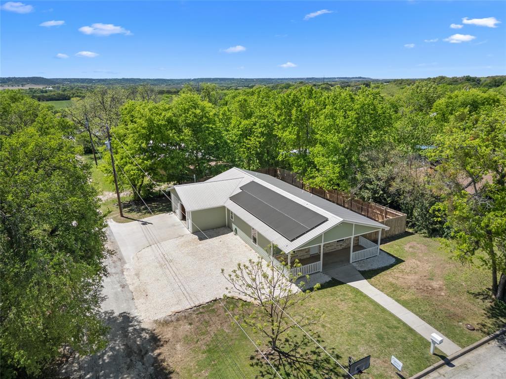 900 Bosque Street Meridian, TX 76665 - Photo 26 of 30 a view of a big house with a big yard and large trees
