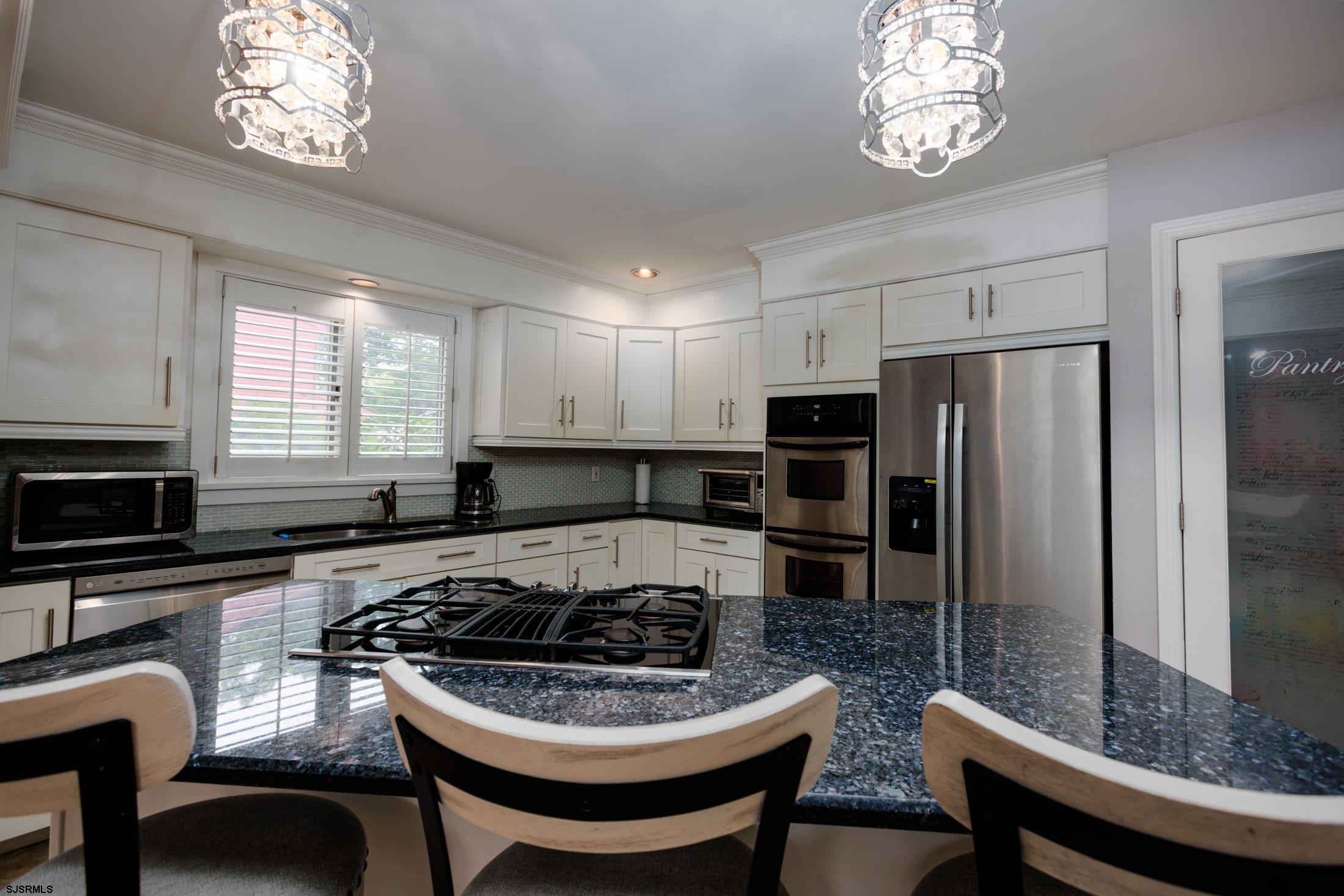816 Chelsea Road Absecon, NJ 08201 - Photo 12 of 41 a kitchen with a dining table and chairs