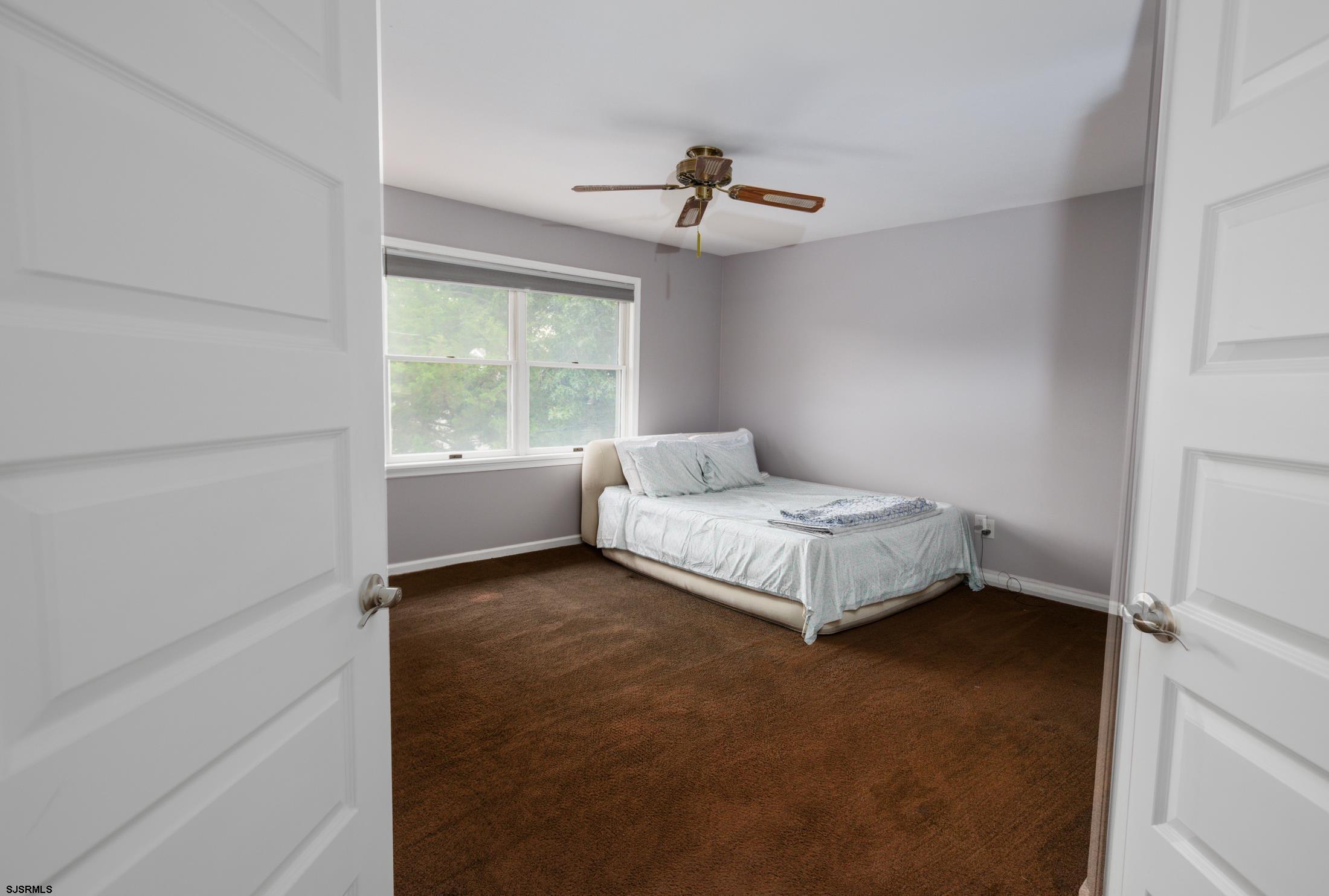 816 Chelsea Road Absecon, NJ 08201 - Photo 22 of 41 a bedroom with a bed and a window
