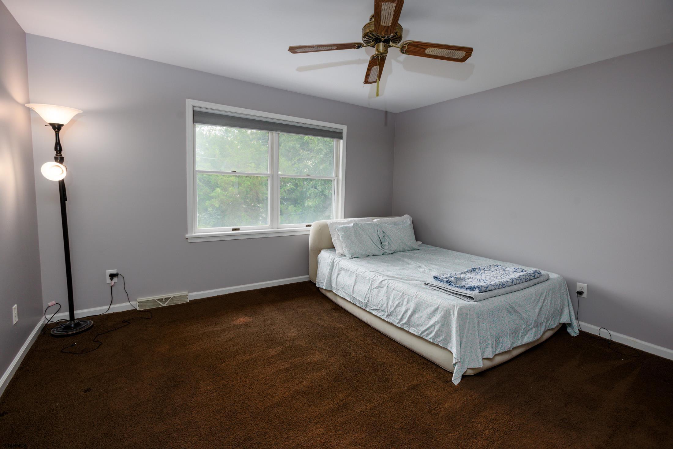 816 Chelsea Road Absecon, NJ 08201 - Photo 24 of 41 a spacious bedroom with a bed and a window