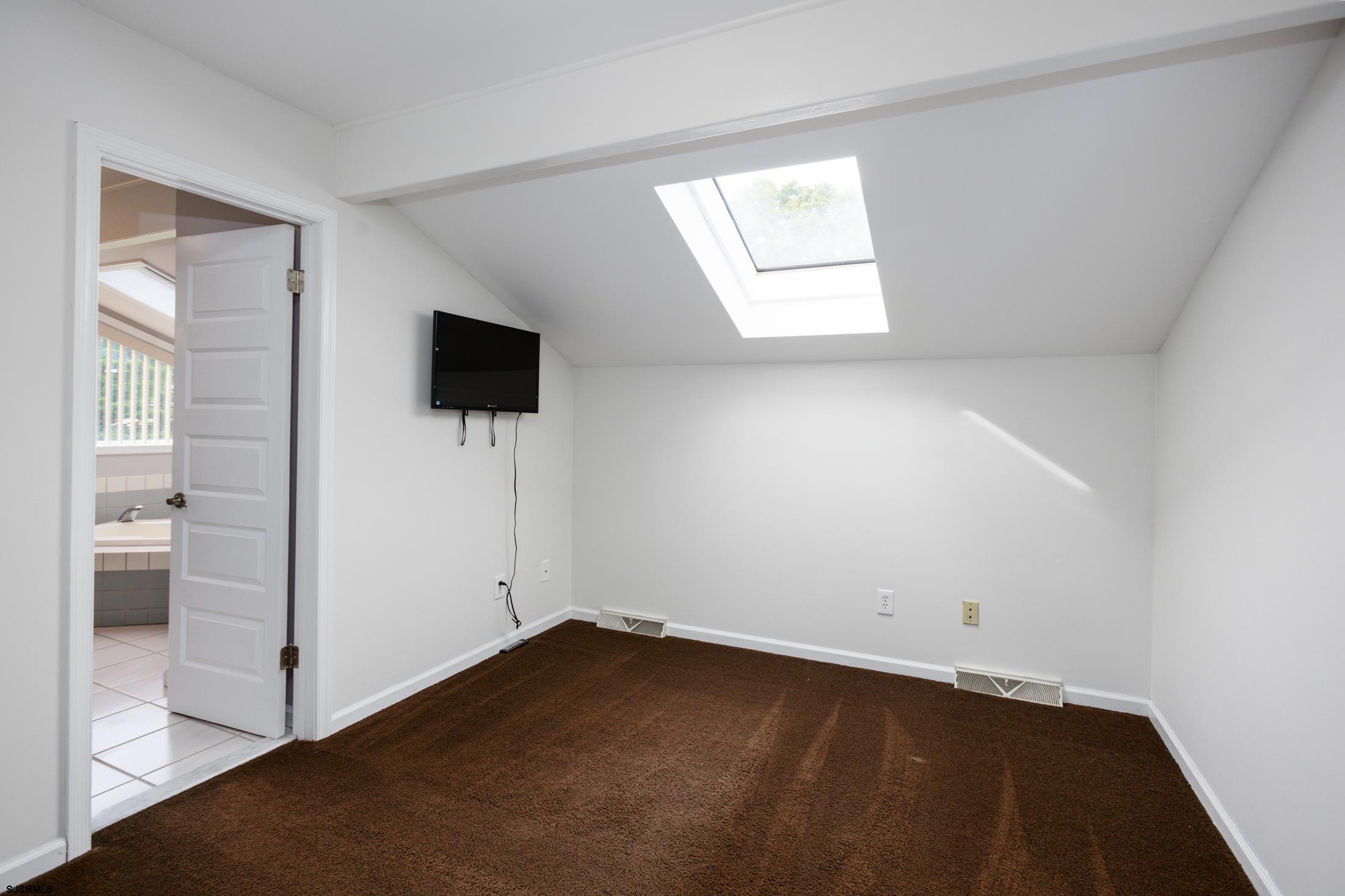 816 Chelsea Road Absecon, NJ 08201 - Photo 30 of 41 an empty room with wooden floor and windows