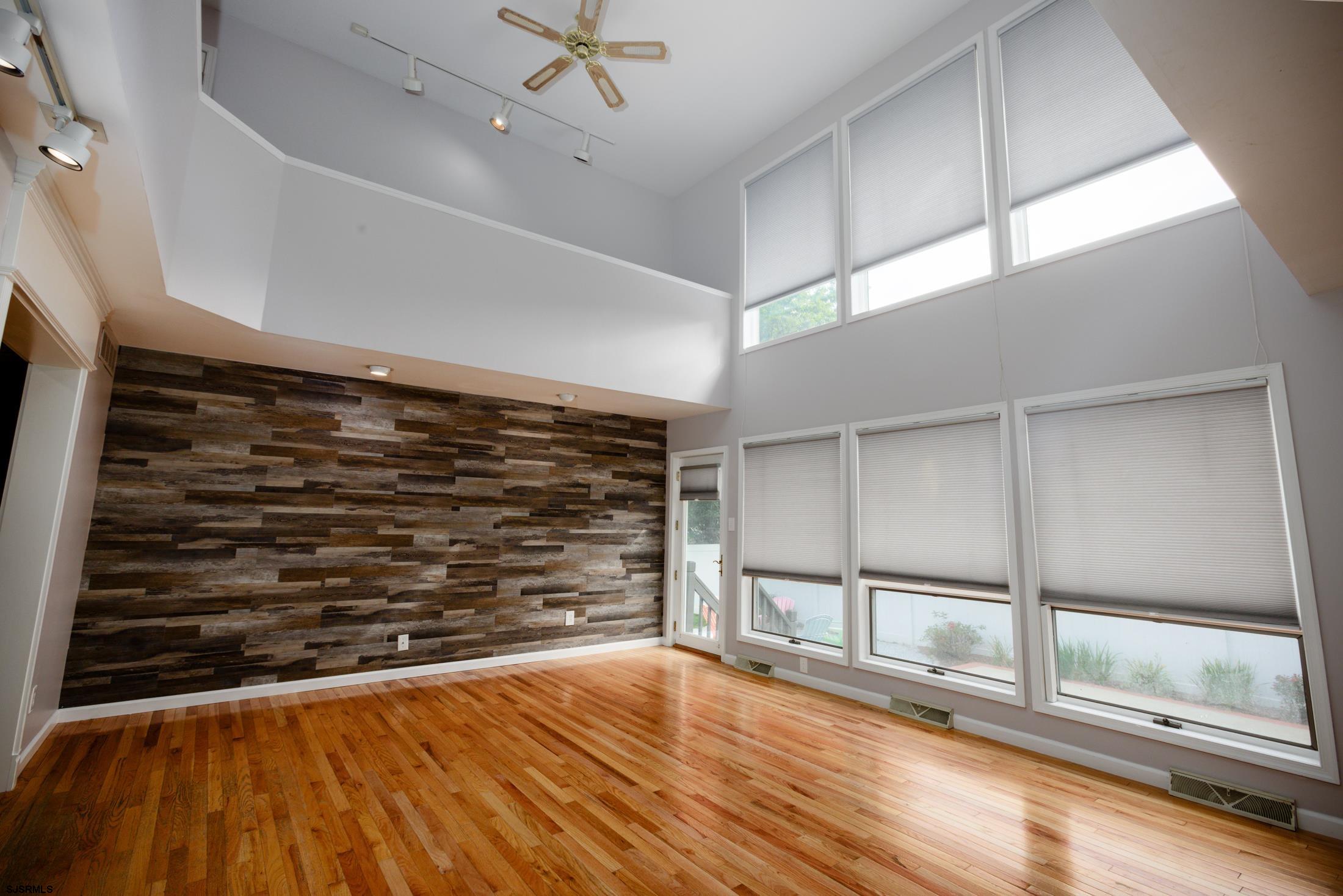 816 Chelsea Road Absecon, NJ 08201 - Photo 7 of 41 a view of an empty room with wooden floor and a window