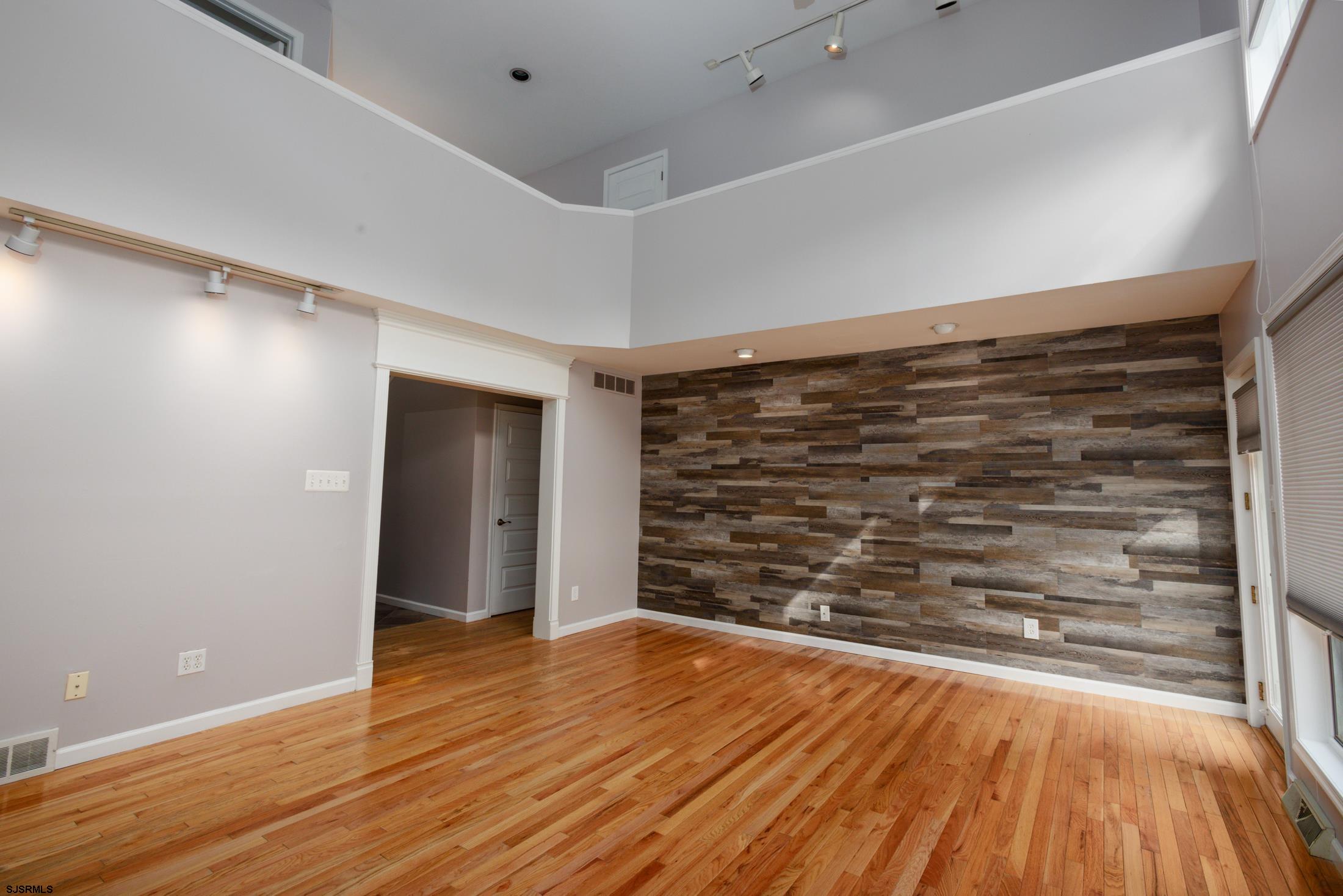 816 Chelsea Road Absecon, NJ 08201 - Photo 8 of 41 a view of an empty room and wooden floor