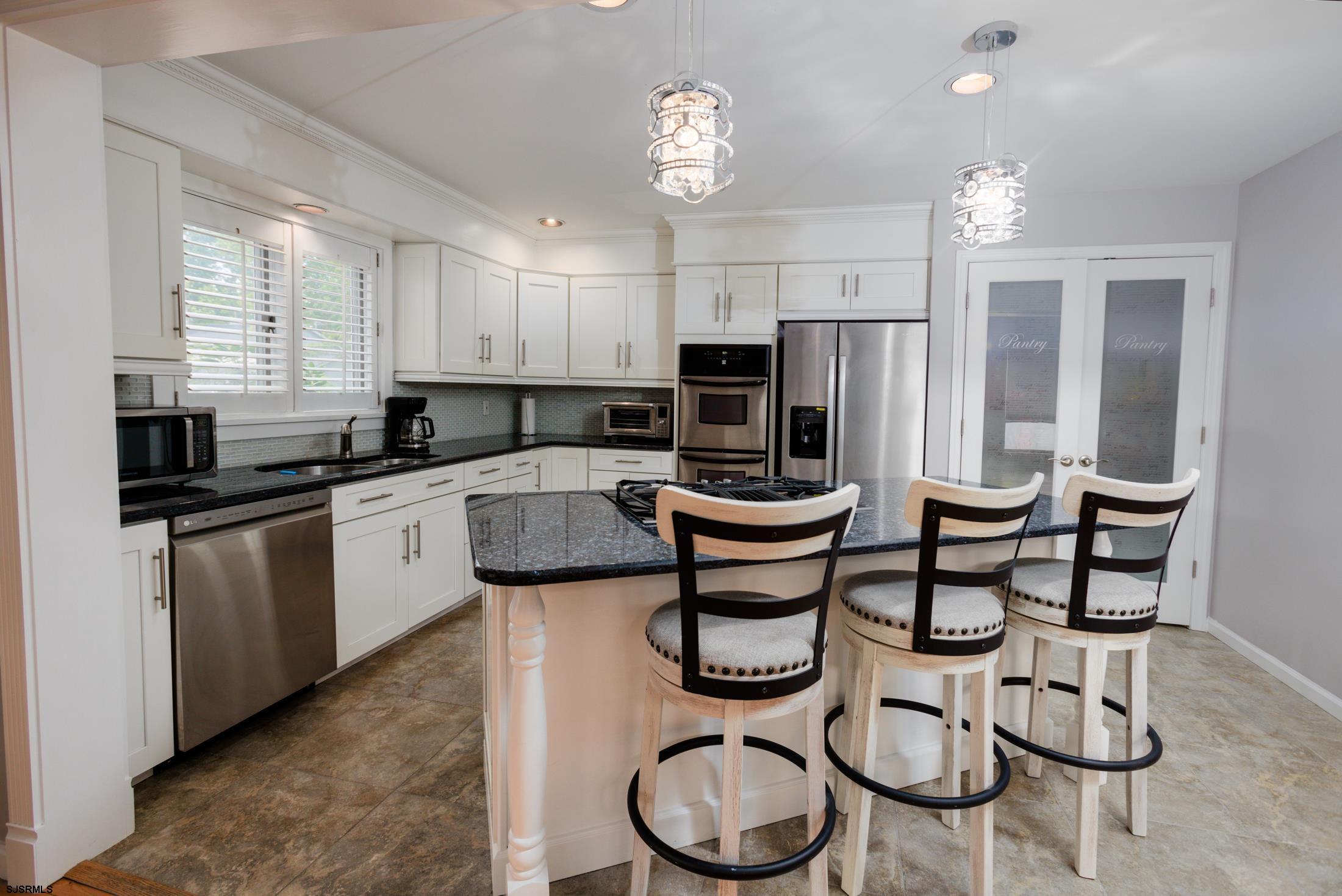 816 Chelsea Road Absecon, NJ 08201 - Photo 10 of 41 a kitchen with a sink a stove a refrigerator and cabinets