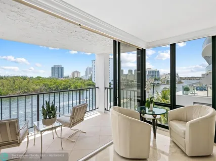 a balcony with furniture and a floor to ceiling window