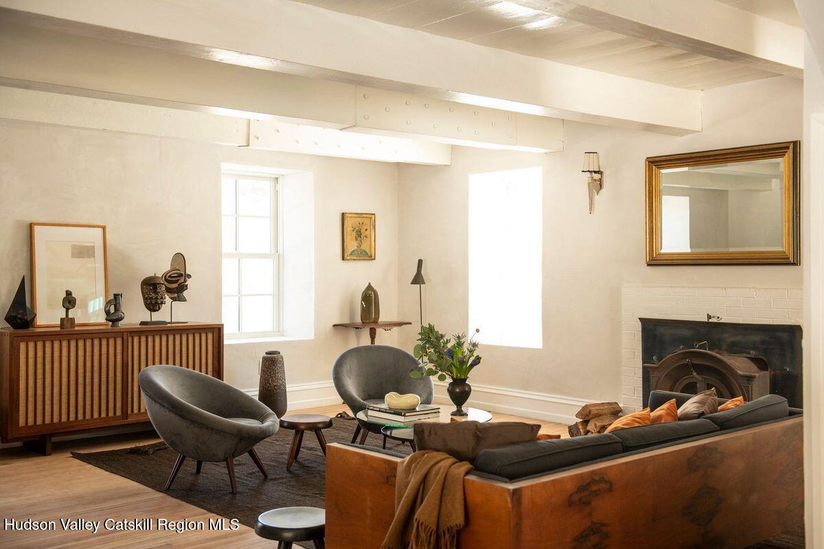 401 Buck Road Stone Ridge, NY 12484 - Photo 14 of 32 a living room with furniture and a fireplace