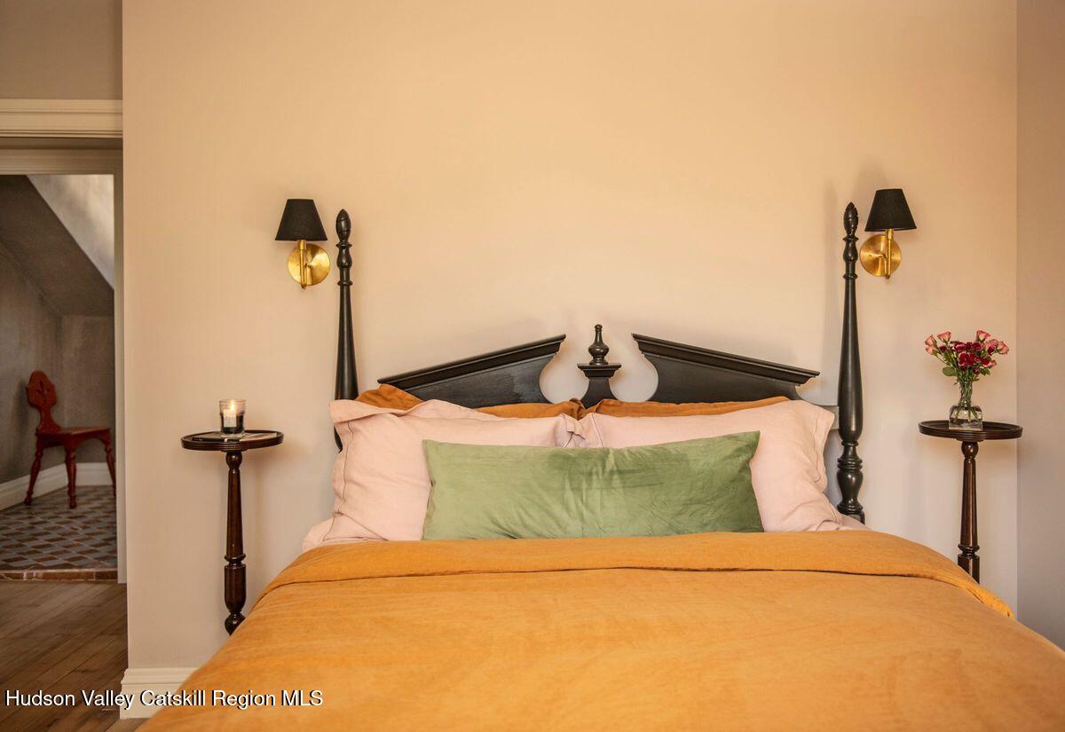 401 Buck Road Stone Ridge, NY 12484 - Photo 21 of 32 a bedroom with a bed and a chandelier