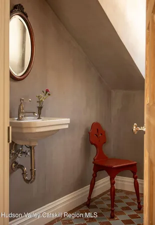 a bathroom with a sink toilet and mirror