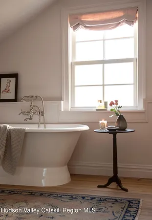 a bathroom with a sink and a window
