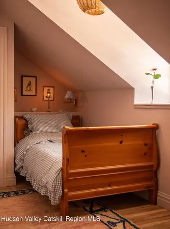 a bed sitting in a bedroom next to a window