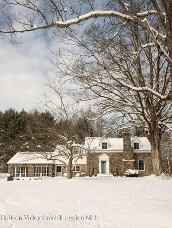 a view of a house with snow in the background
