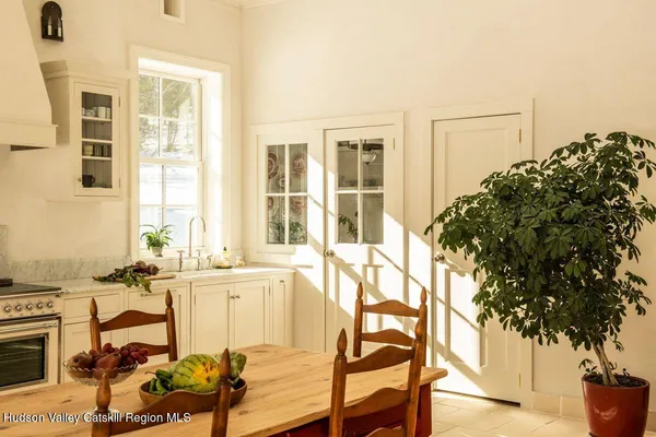 a living room with a couch and potted plants