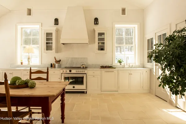 a kitchen with a sink stove and white cabinets