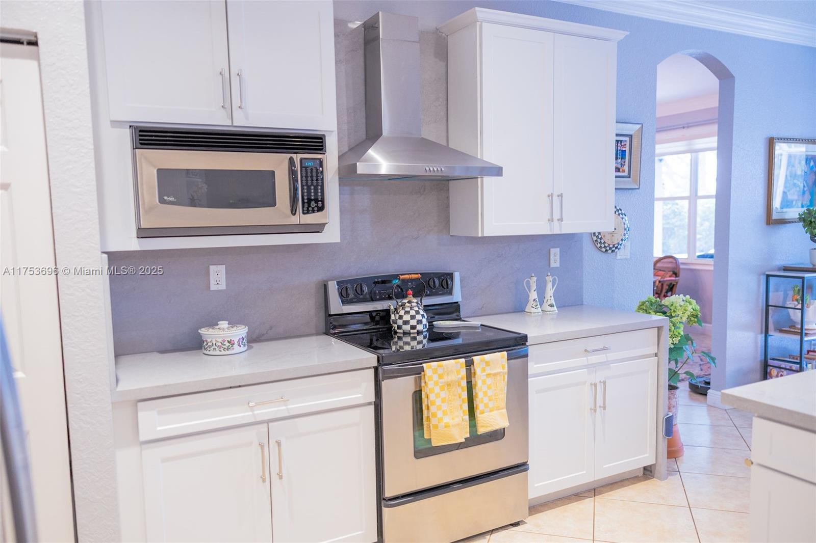 3923 Cascade Terrace Weston, FL 33332 - Photo 20 of 82 a kitchen with stainless steel appliances granite countertop a stove sink and cabinets