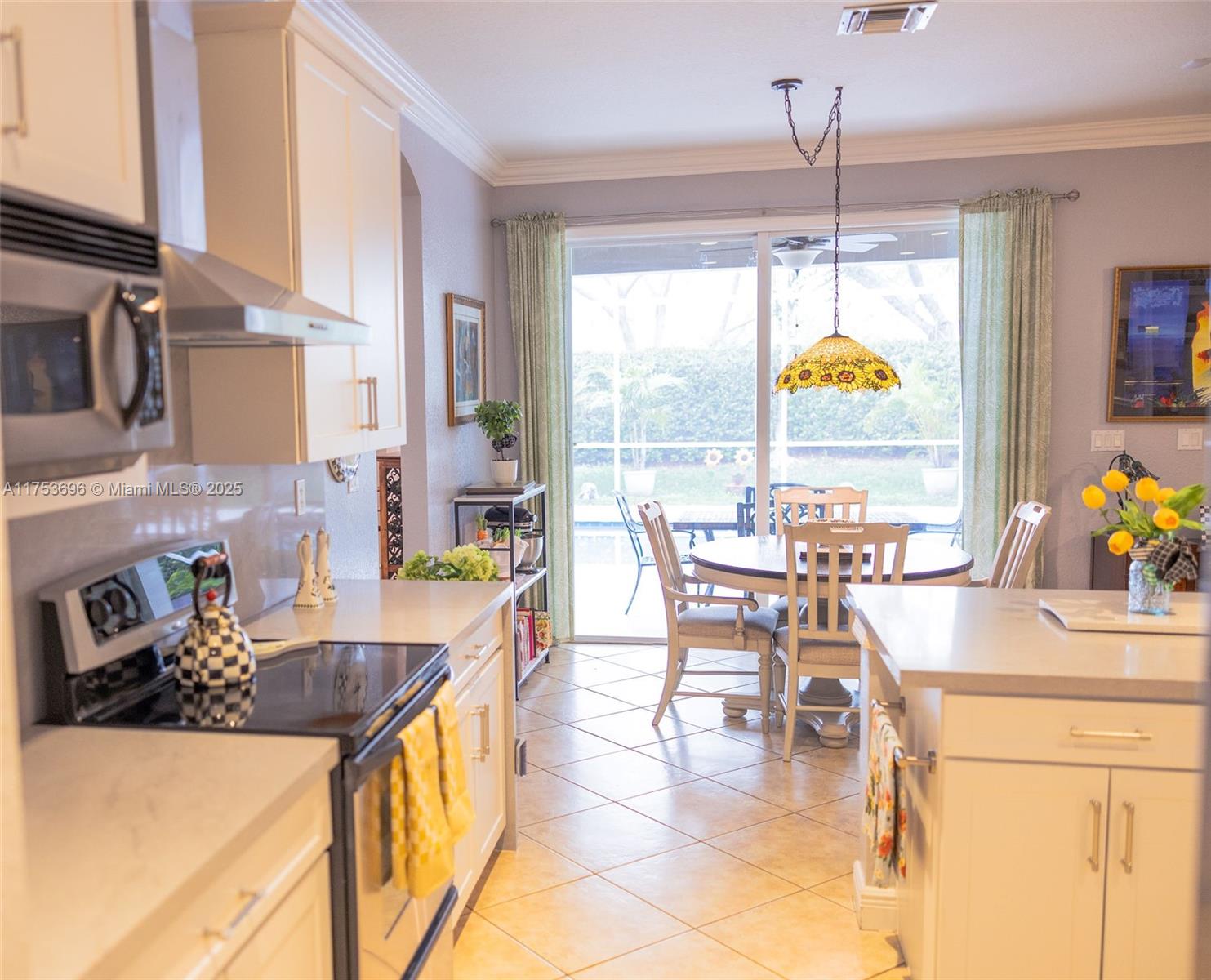 3923 Cascade Terrace Weston, FL 33332 - Photo 28 of 82 a kitchen with stainless steel appliances granite countertop a stove and a table chair