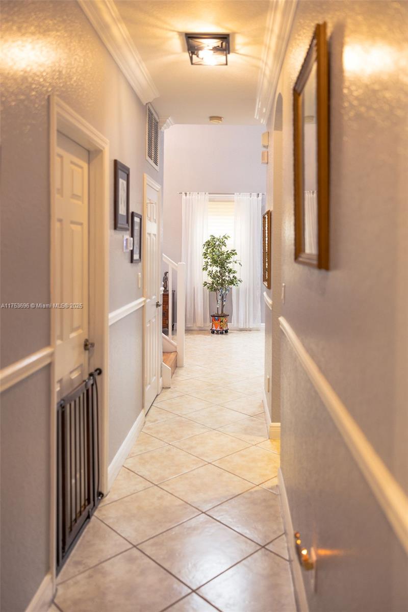 3923 Cascade Terrace Weston, FL 33332 - Photo 36 of 82 a view of a hallway with wooden floor and a living room