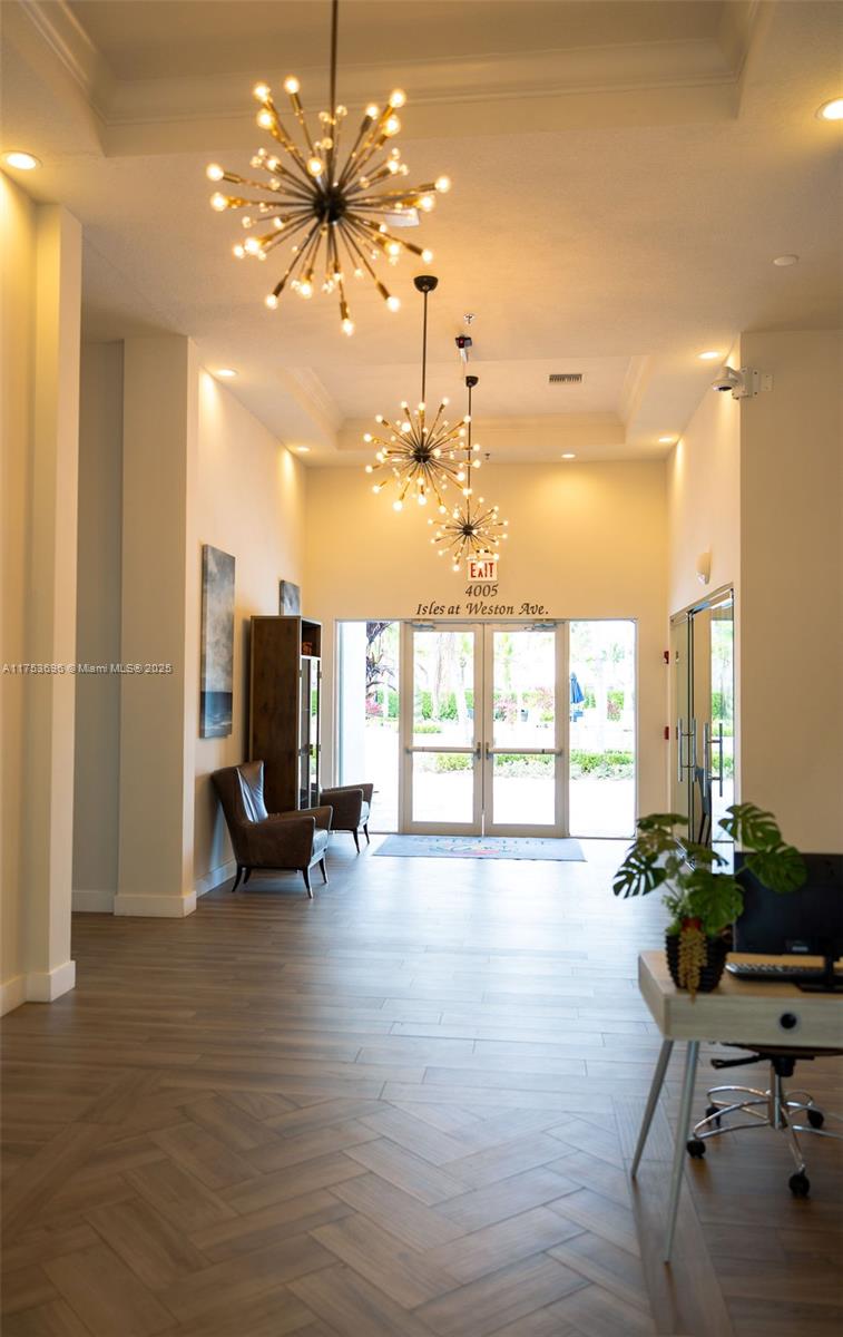 3923 Cascade Terrace Weston, FL 33332 - Photo 76 of 82 a view of a workspace with furniture and a chandelier