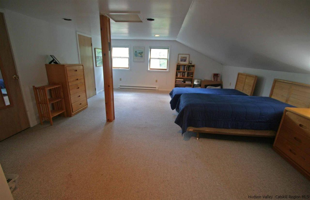 318 Autumn Breeze Road Roxbury, NY 12421 - Photo 26 of 35 a spacious bedroom with a bed and a view in closet