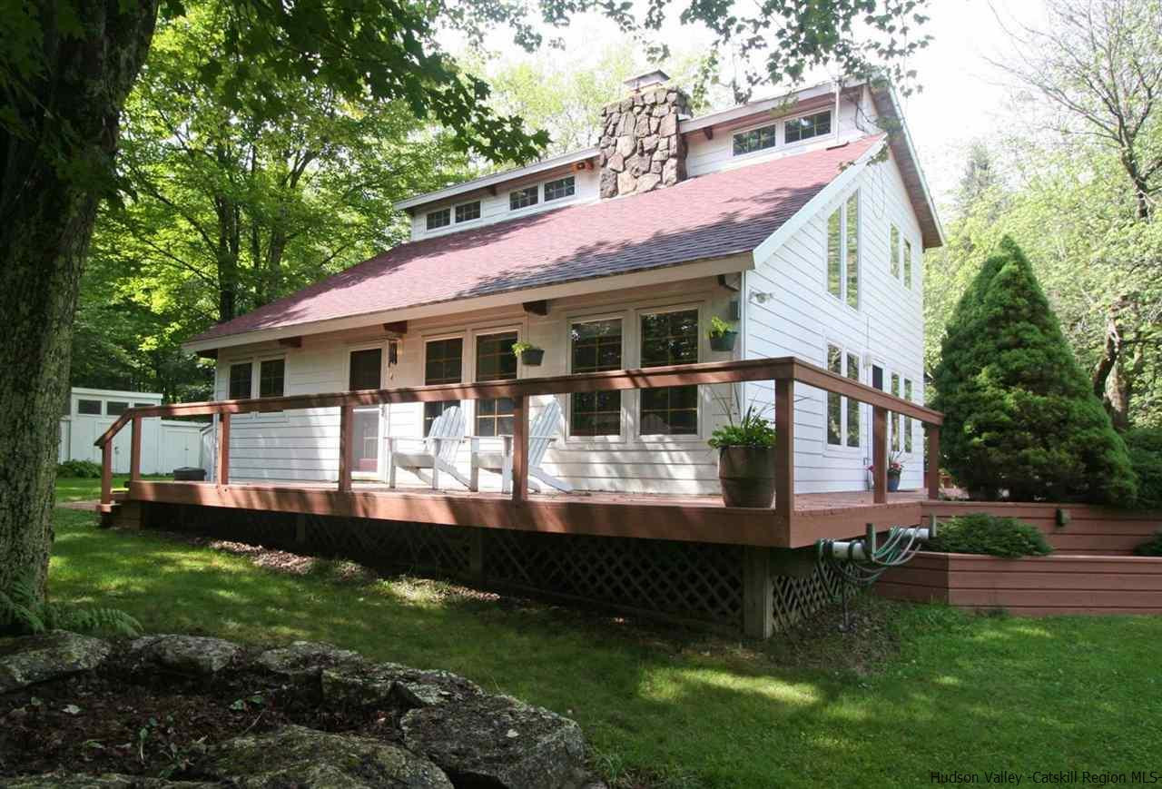 318 Autumn Breeze Road Roxbury, NY 12421 - Photo 3 of 35 a front view of a house with a yard deck and a patio