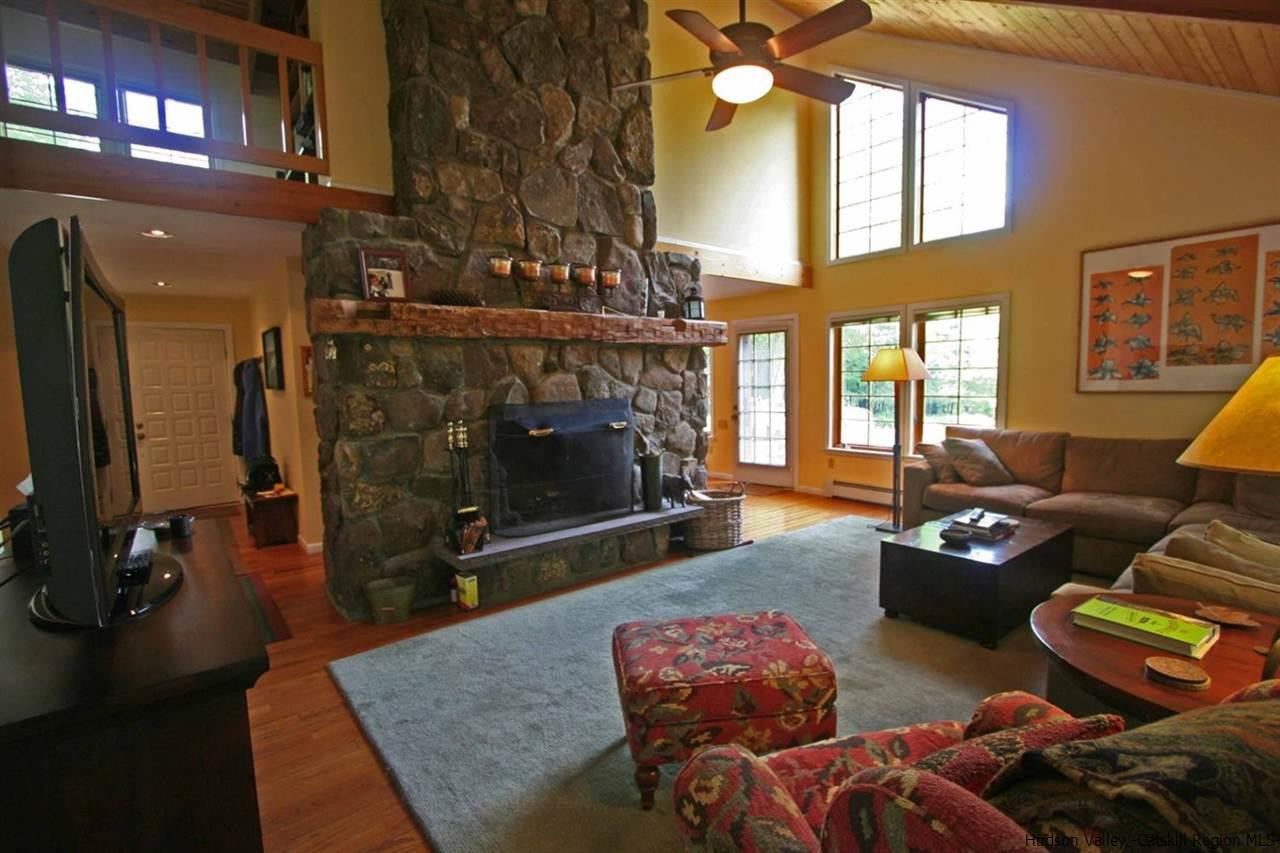 318 Autumn Breeze Road Roxbury, NY 12421 - Photo 8 of 35 a living room with furniture a fireplace and a flat screen tv