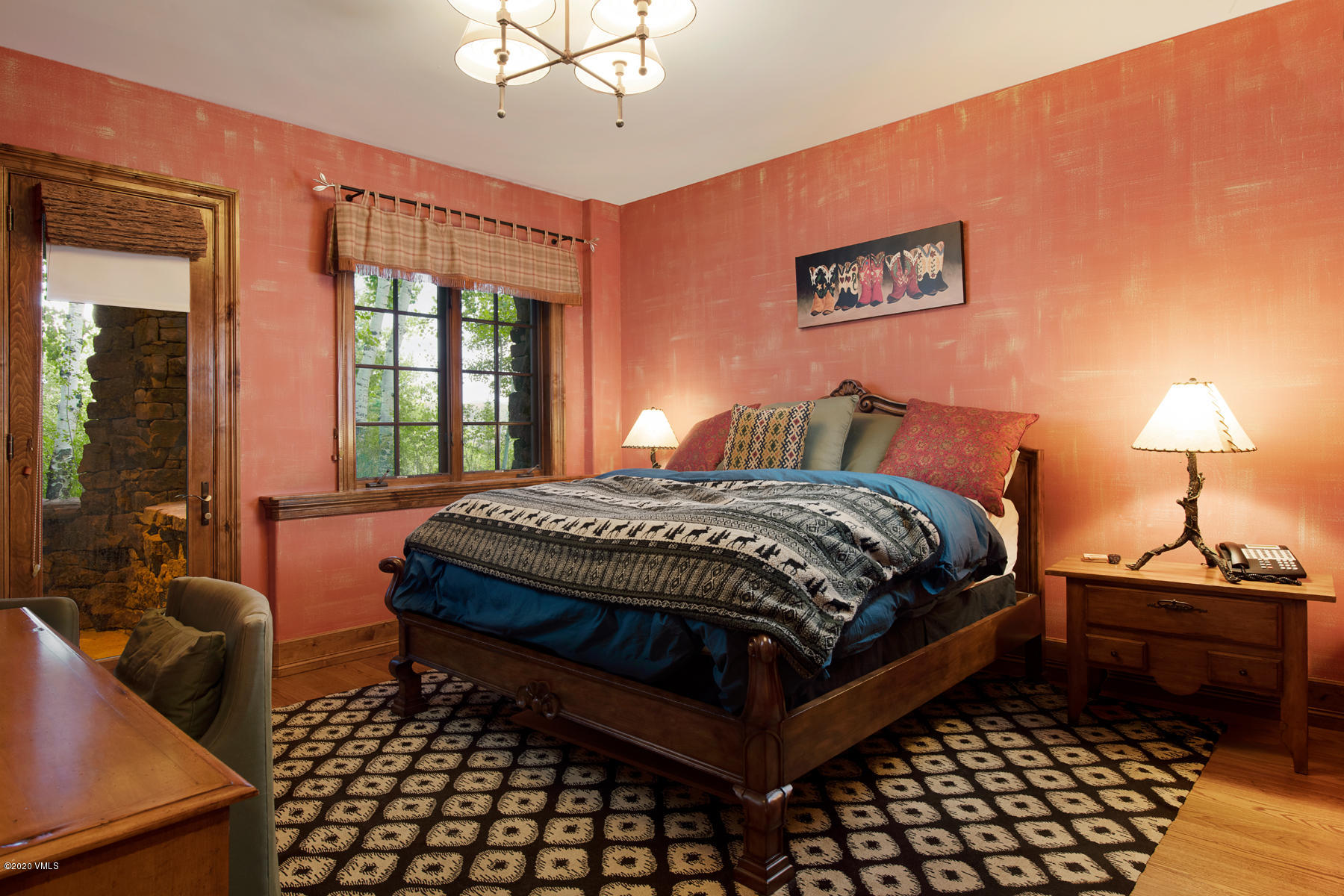 919 Bachelor Ridge Road Avon, CO 81620 - Photo 22 of 31 a bedroom with a bed and wooden floor