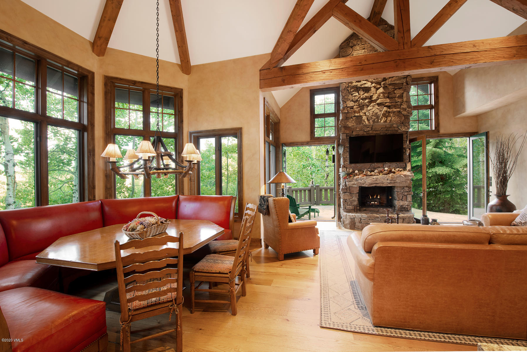 919 Bachelor Ridge Road Avon, CO 81620 - Photo 9 of 31 a living room with fireplace furniture and a floor to ceiling window