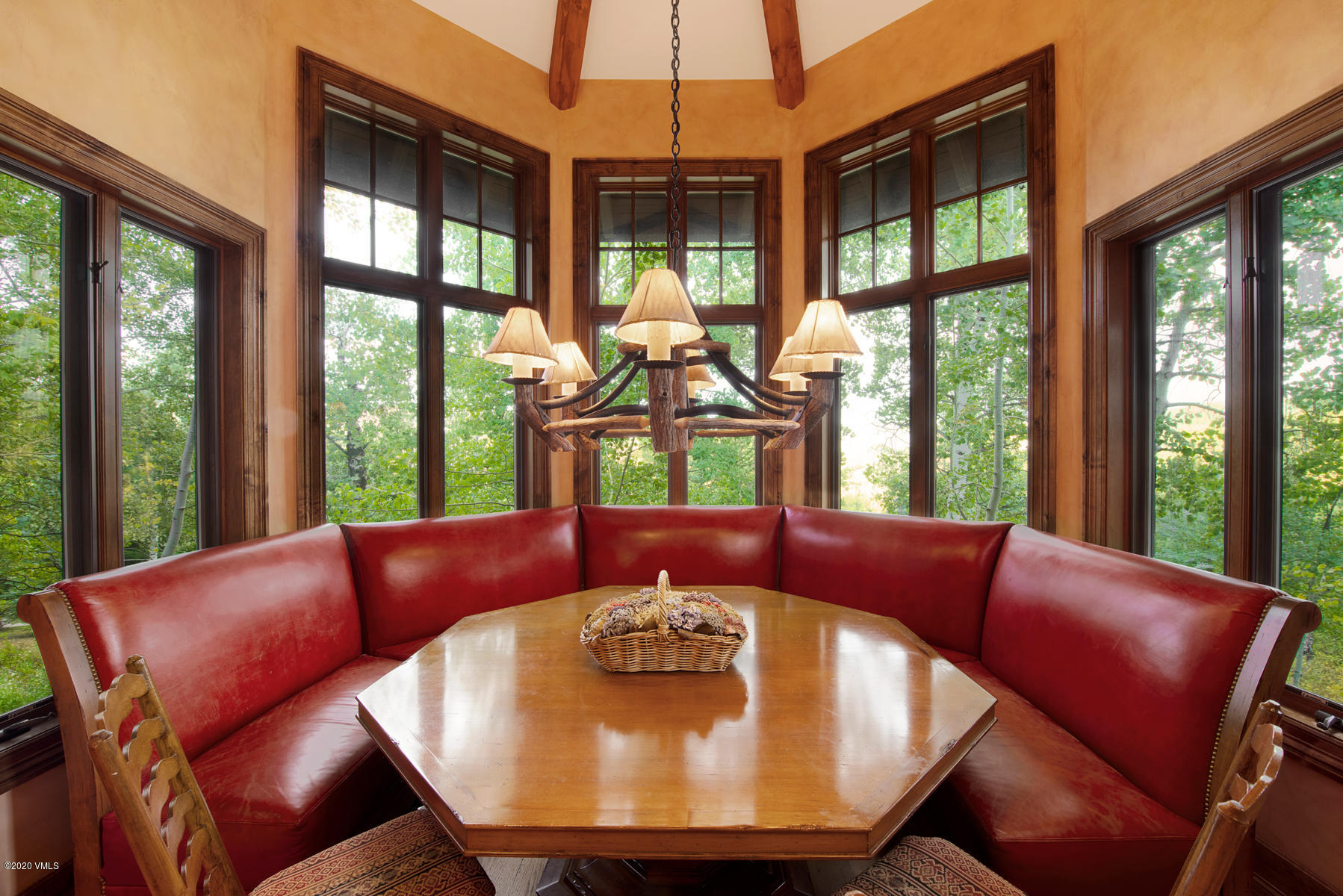 919 Bachelor Ridge Road Avon, CO 81620 - Photo 10 of 31 a view of a dining room with furniture large windows and a chandelier