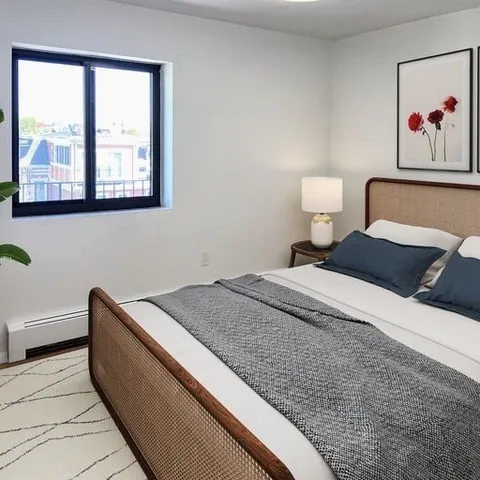 a bedroom with a bed and a painting on the wall