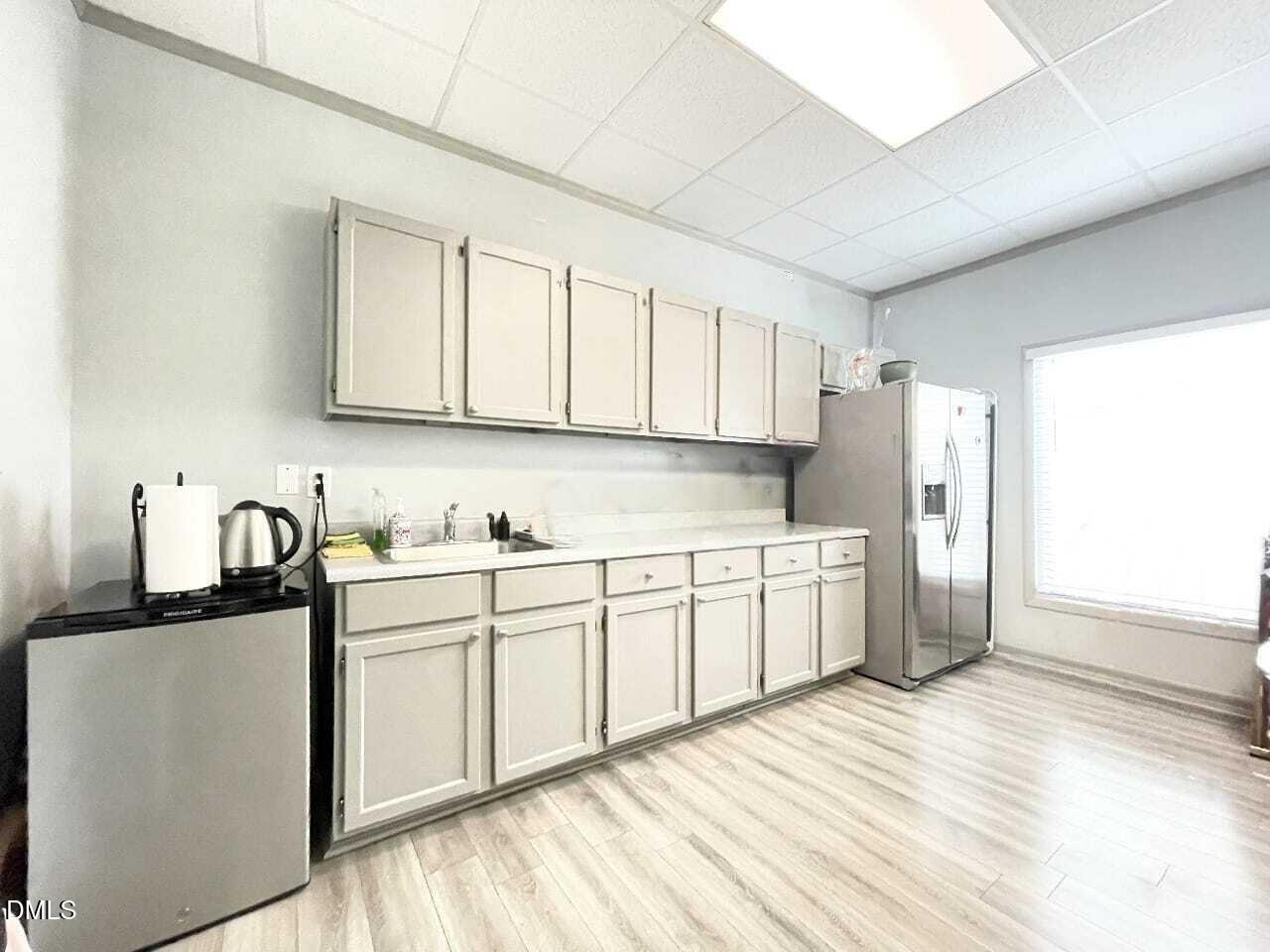 901 Kildaire Farm Road, Unit D1 Cary, NC 27511 - Photo 9 of 13 a kitchen with stainless steel appliances granite countertop a sink cabinets and wooden floor